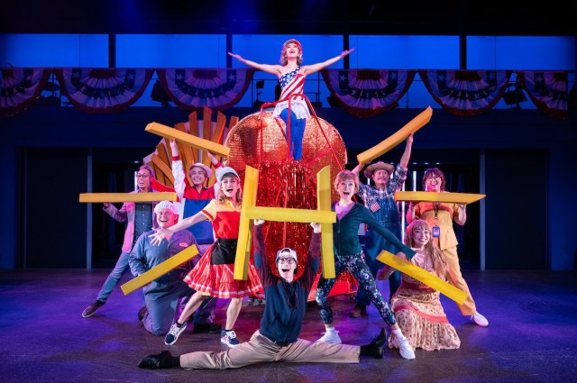 Grace Yoo (Hillary Clinton, center) and the cast of Soft Power at the Signature Theatre. Photo by Daniel Rader